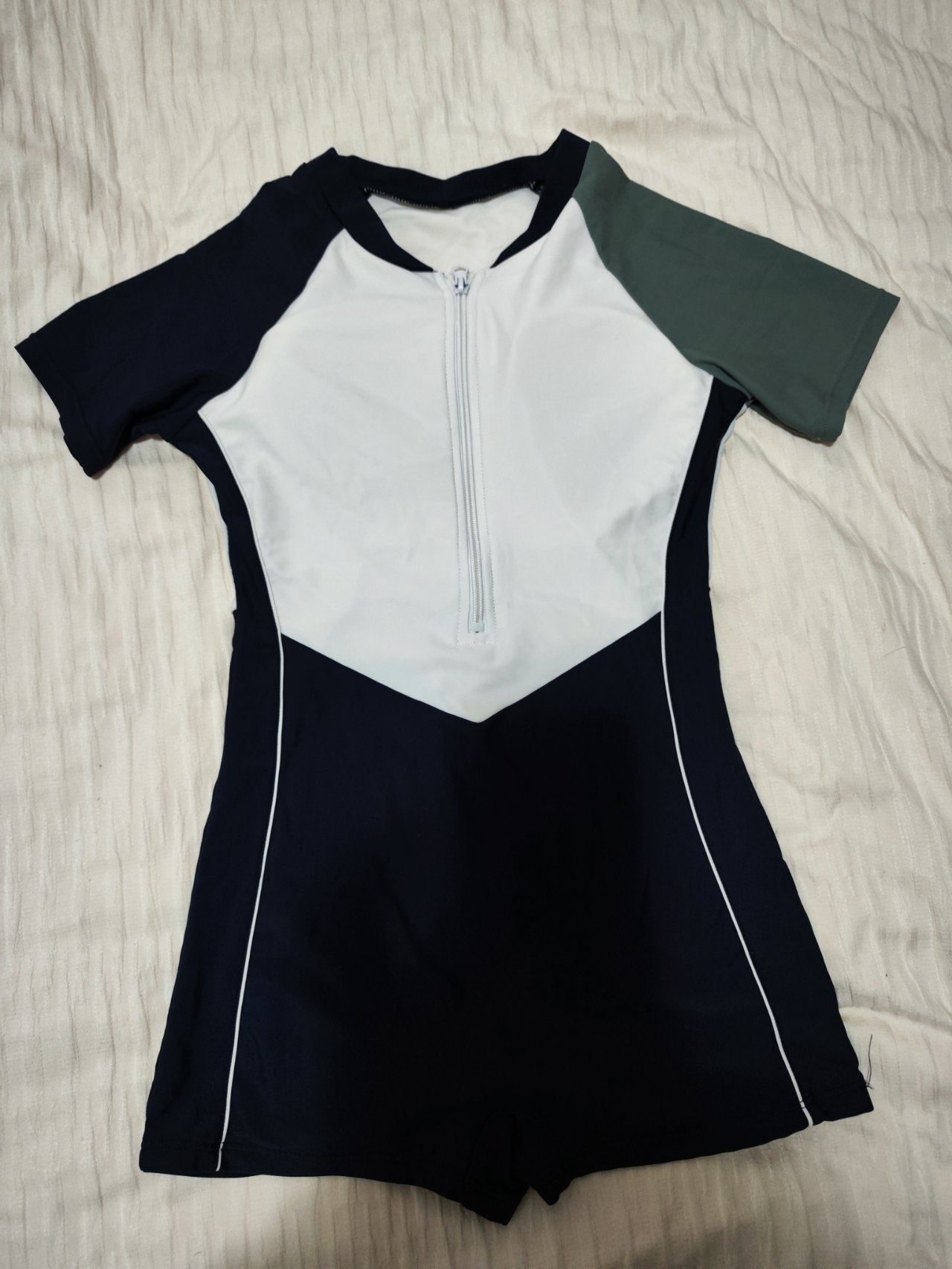 abely short sleeve boyleg black swimsuit flatlay leg panel detail abely short sleeve boyleg black swimsuit flatlay leg panel detail