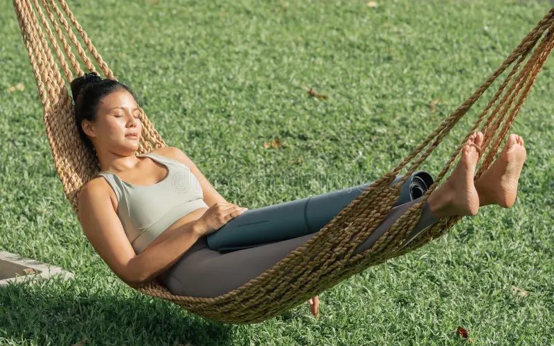 portrait beautiful asian adult sportive woman wearing sport bra resting taking nap sleeping cradle calm outdoor