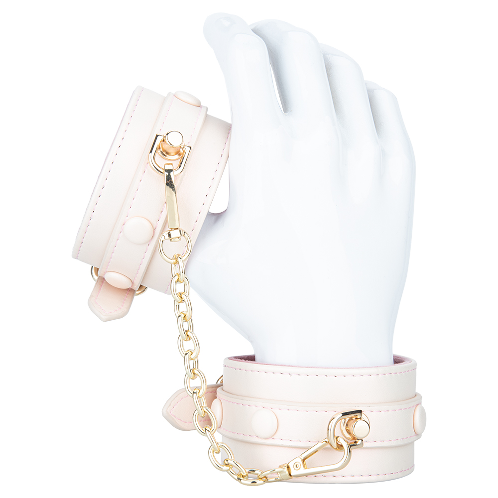 Imbracatura regolabile in pelle PU foderata in peluche rosa crema con set di manette con grillo