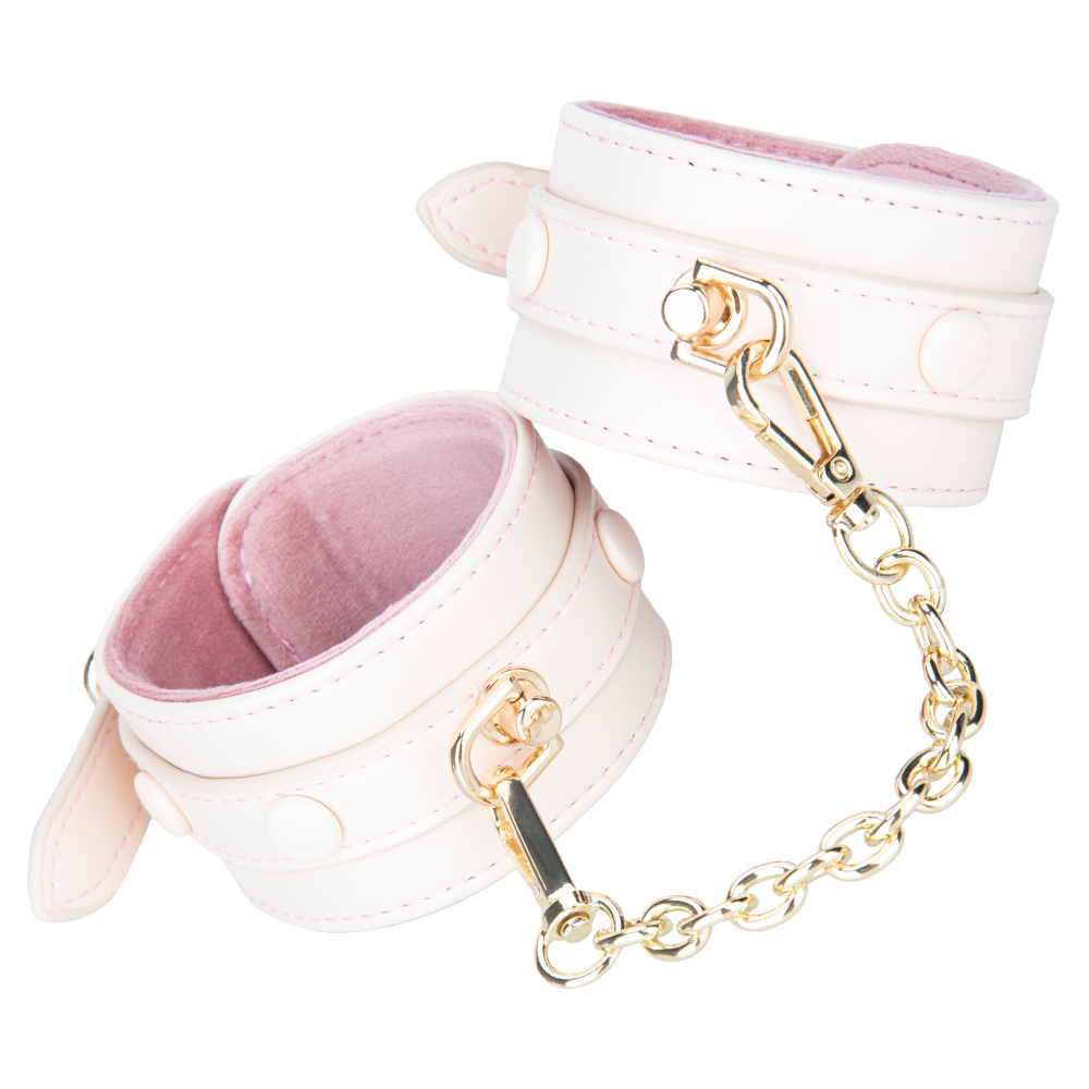 Imbracatura regolabile in pelle PU foderata in peluche rosa crema con set di manette con grillo
